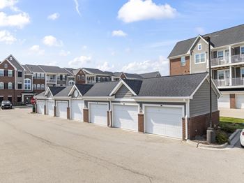 A row of houses with garages in front.